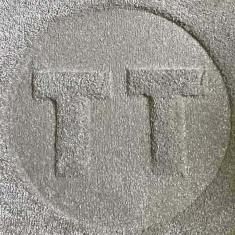 Letters T and T pressed into carpet giving logo effect