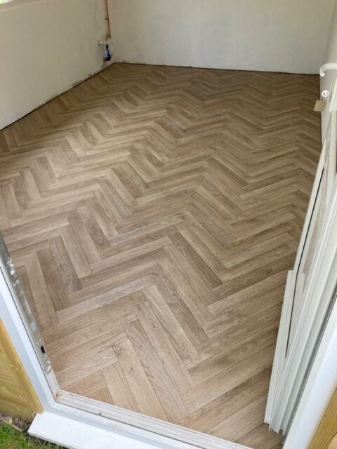 Herringbone wood flooring in outhouse